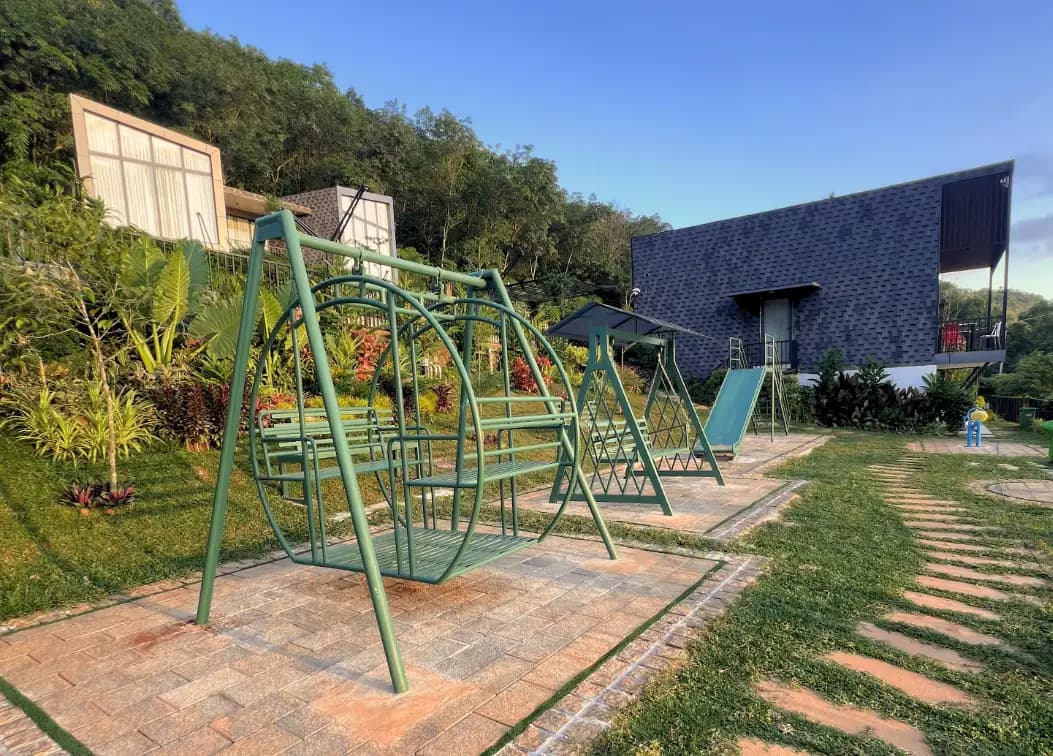 Children's play area with swings at Peakdays Retreats